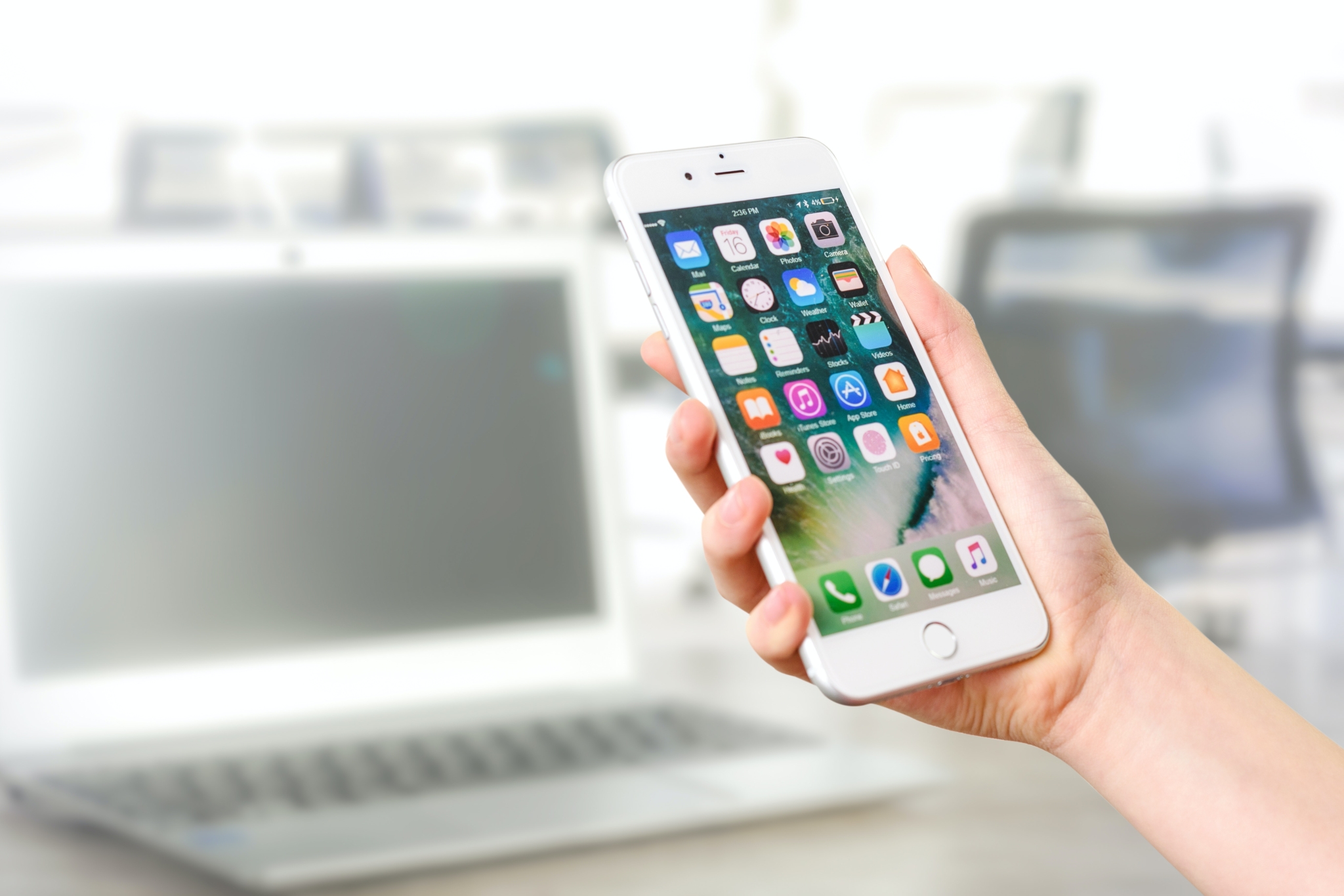 iPhone home screen in hand