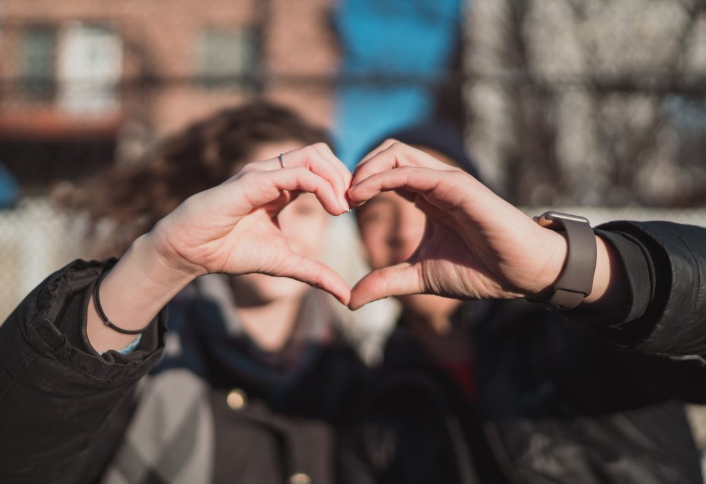 couple using hands to make heart shape