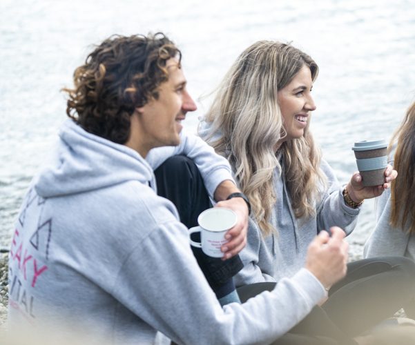 Ben and Natalie drinking coffee on the beach