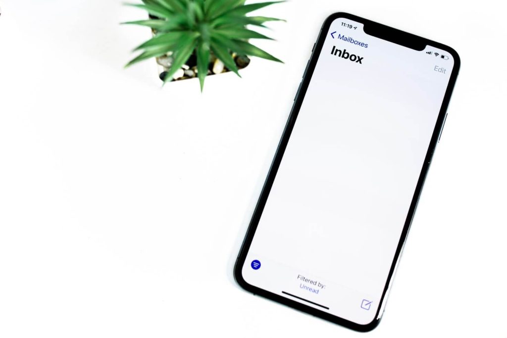 Iphone emails next to plants